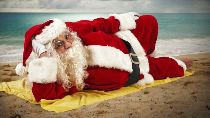 Santa Claus relaxing on a beach