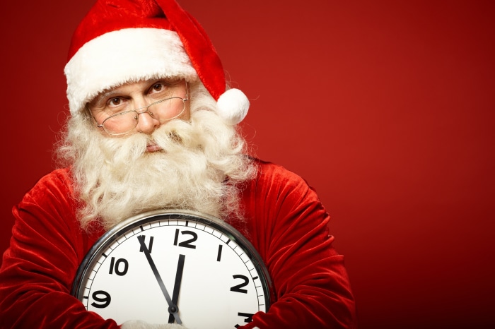 Santa Claus holding a clock