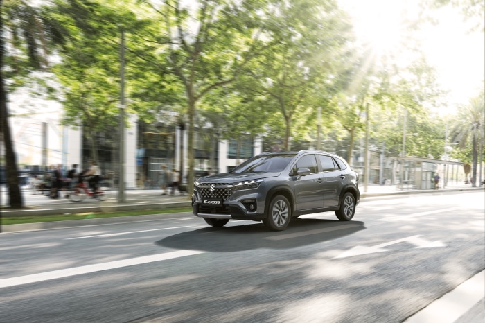 Suzuki S-Cross Hybrid SUV driving on a sunny street