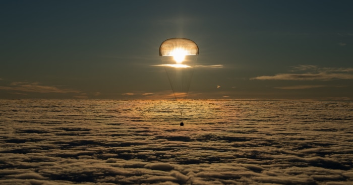 Soyuz MS-06 Space Capsule Landing with Parachute at Sunset