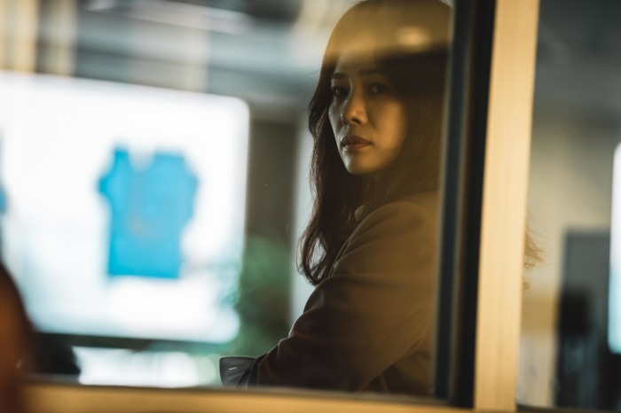 Woman looking through a window