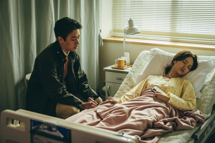 Man visits woman in hospital bed