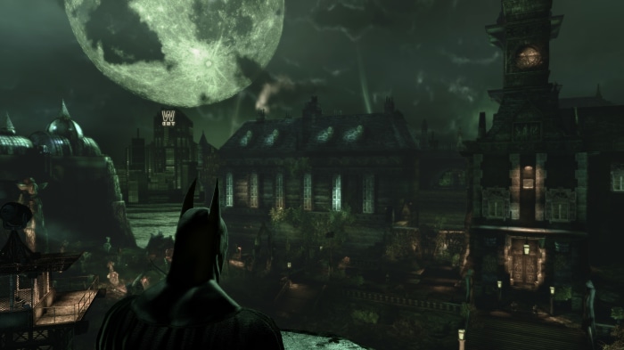 Batman overlooking Arkham Asylum at night