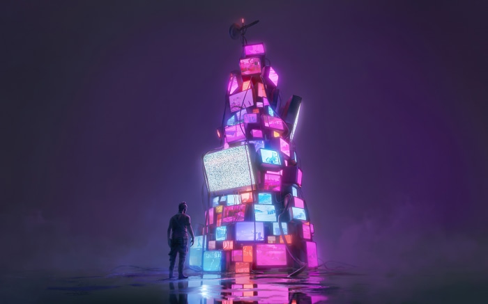 Man looking at a tower of old TVs