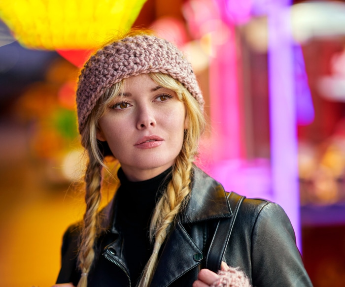 Woman with blonde braids and pink headband