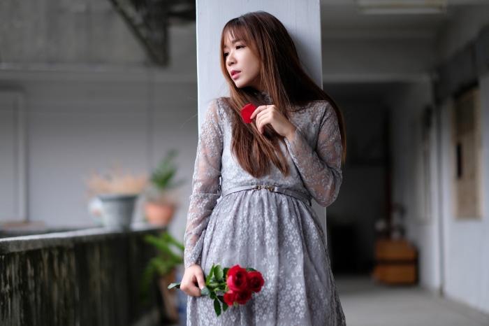 Asian woman with red heart and roses
