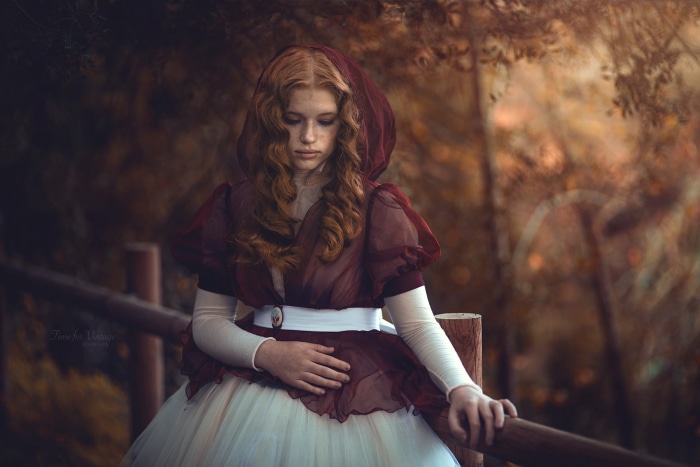 Redhead girl in a vintage dress outdoors