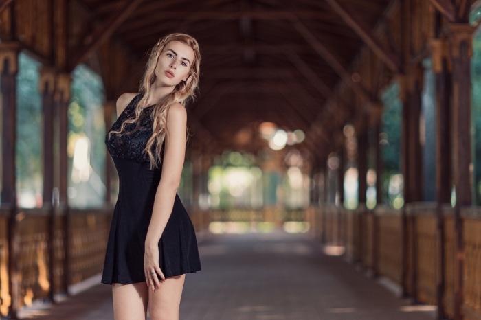 Woman in black dress on wooden walkway