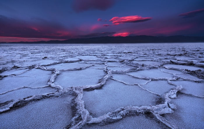Death Valley desert cracked earth at sunset