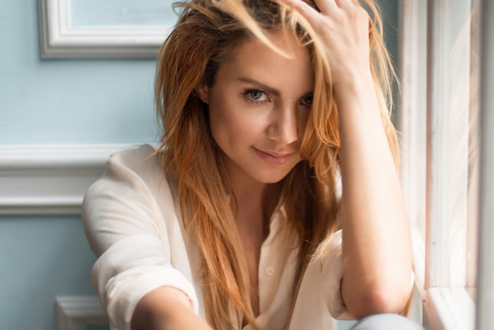Redhead woman with hand in hair