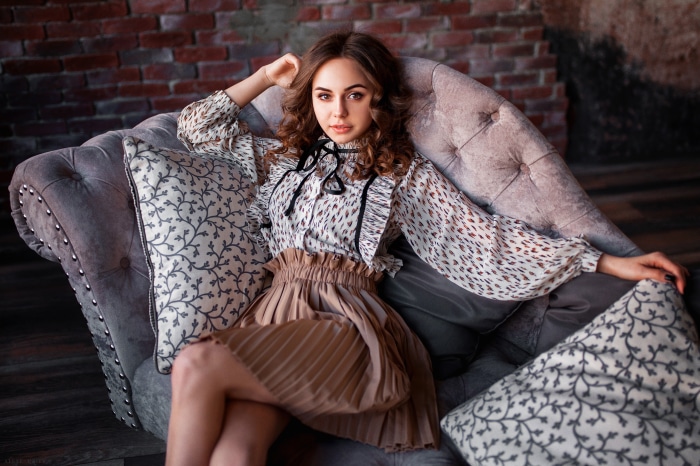Brunette woman sitting on a sofa