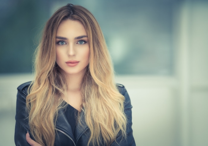 Woman with blonde hair wearing a leather jacket