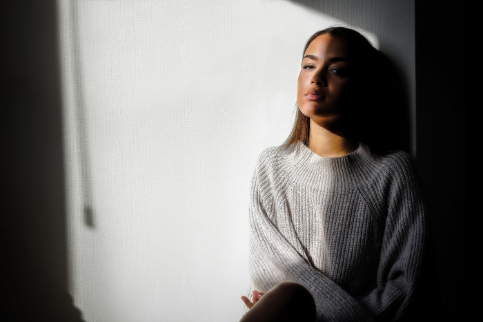 Woman in a sweater with light and shadow