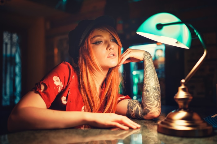 Woman with tattoos and red hair at a bar