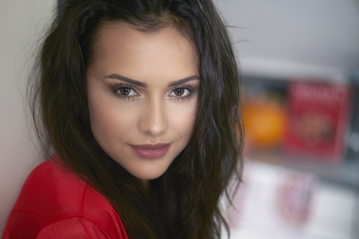 Woman with black hair wearing red