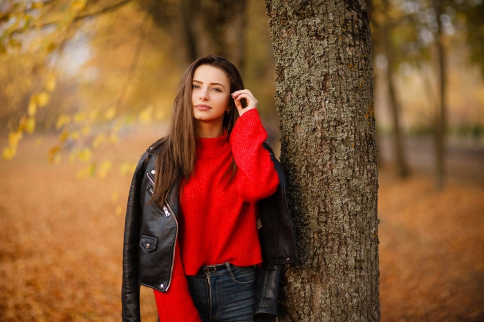 Brunette woman in red sweater and leather jacket