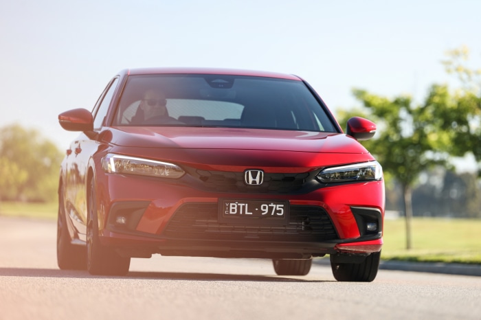 Red Honda Civic Hatchback with license plate BTL-975