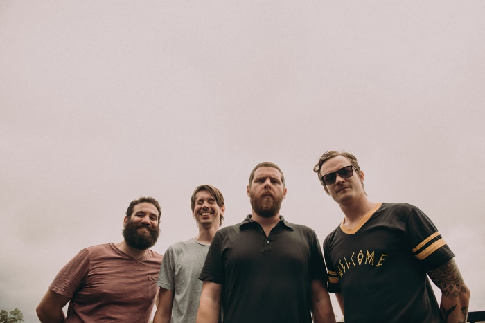 Manchester Orchestra band members posing outdoors