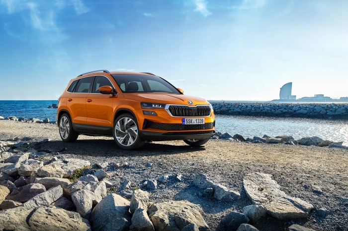 Orange Škoda Karoq SUV parked by the sea