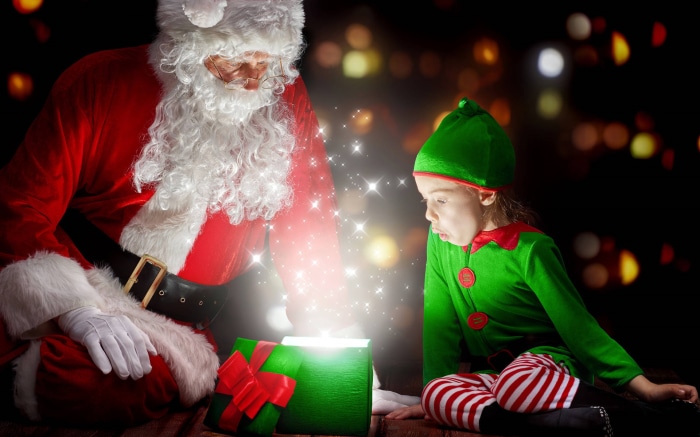 Santa Claus and Elf Opening a Magical Christmas Gift