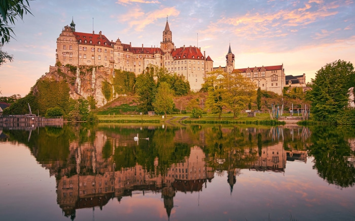 Sigmaringen Castle reflected in a lake at sunset