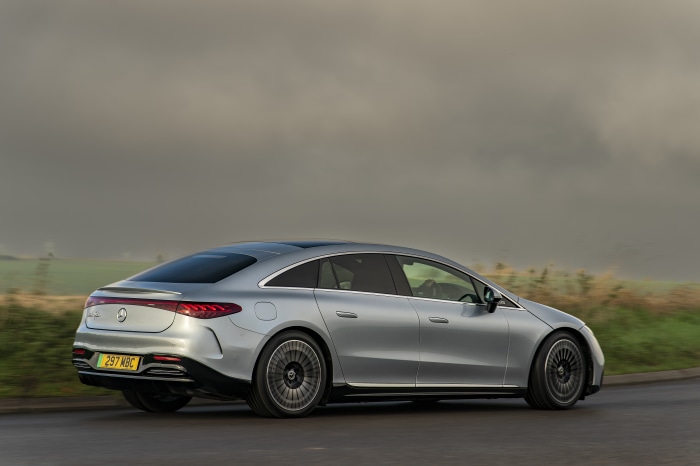 Silver Mercedes-Benz EQS 450 AMG Line driving on a road
