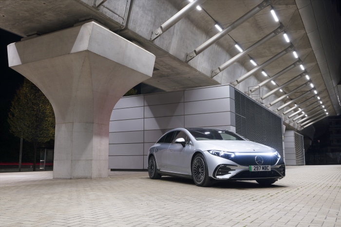 Silver Mercedes-Benz EQS 450 AMG Line parked under a bridge