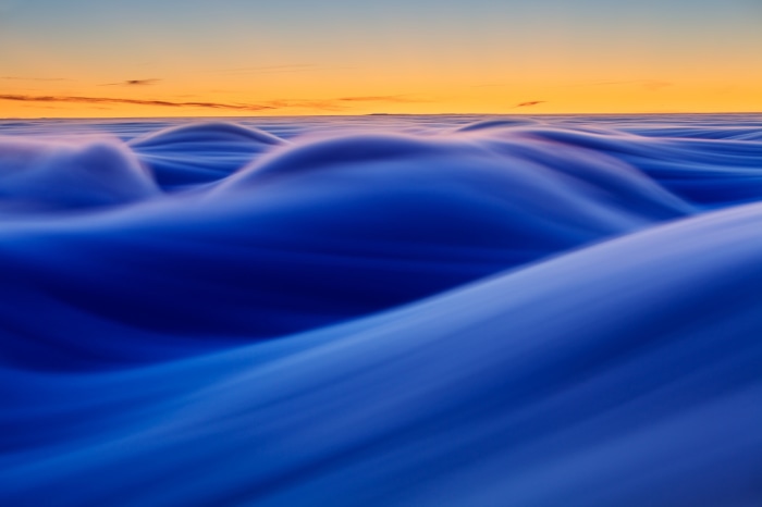 Abstract Blue Waves Under Orange Sky