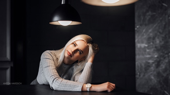 Woman with blonde hair wearing a grey sweater