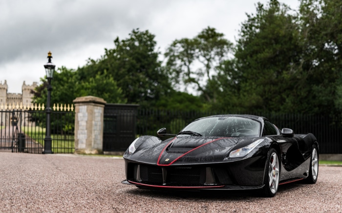 Black Ferrari LaFerrari Aperta parked near a castle