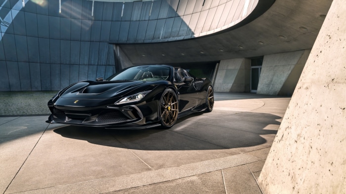 Black Ferrari F8 Spider parked in modern architecture
