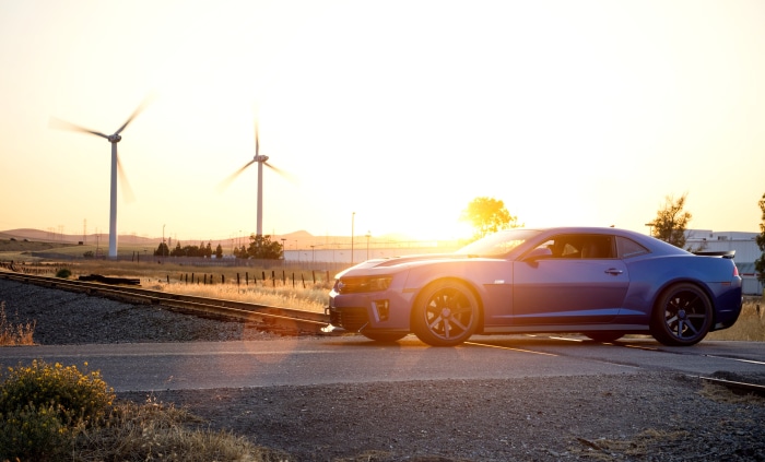 Blue Chevrolet Camaro ZL1 4K near wind turbines