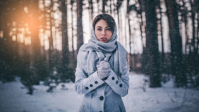 Woman in winter forest with snow