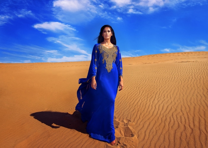 Woman in blue dress in desert