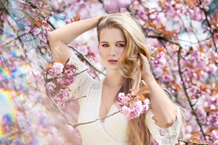 Woman Posing Among Cherry Blossoms