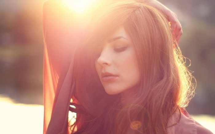 Woman with red hair in sunlight