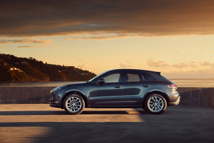 Porsche Macan SUV parked by the ocean at sunset