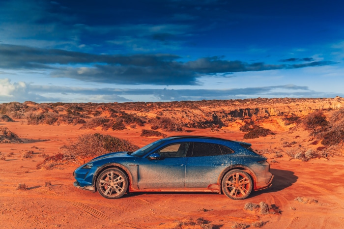 Blue Porsche Taycan 4S Cross Turismo in a desert landscape