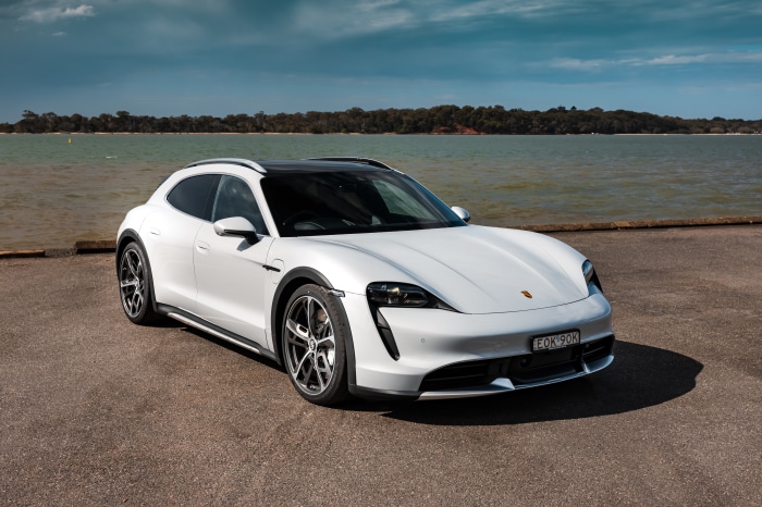 White Porsche Taycan Turbo Cross Turismo by the water