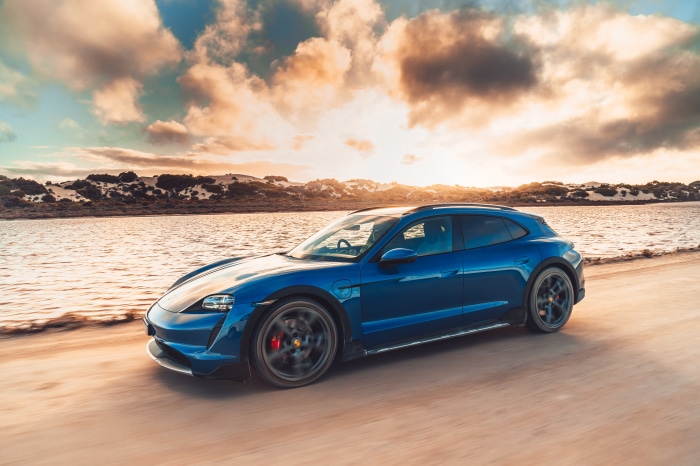 Blue Porsche Taycan 4S Cross Turismo driving on a beach