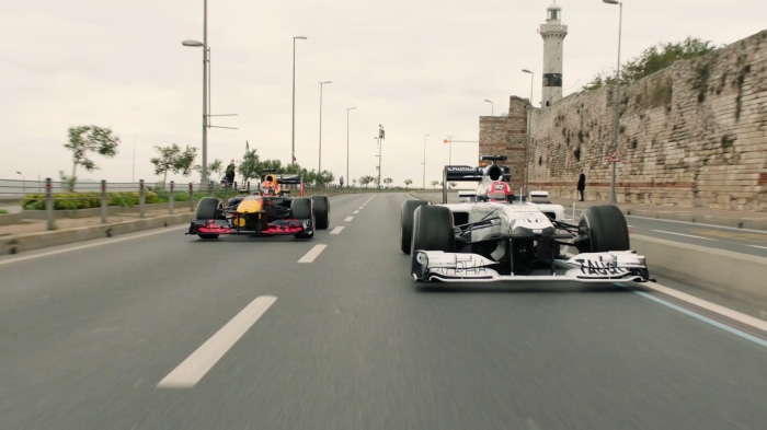 Red Bull Racing and Scuderia AlphaTauri Formula 1 cars on road