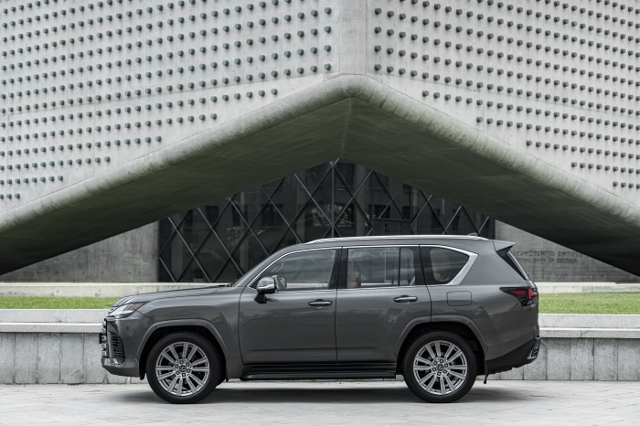 Lexus LX 600 SUV parked in front of a modern building
