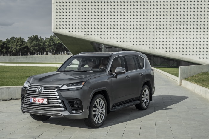 Lexus LX 600 SUV parked in front of a modern building