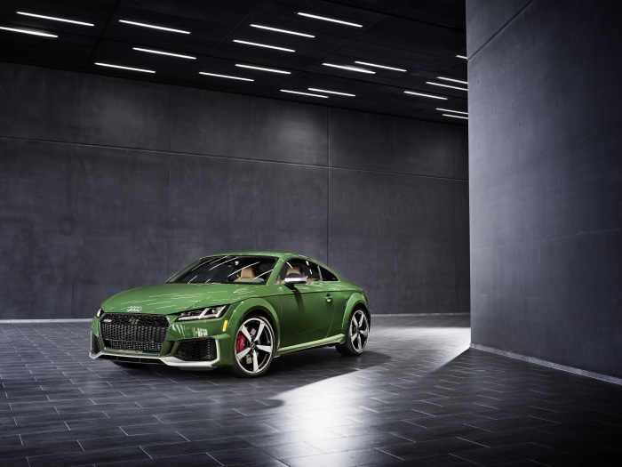 Green Audi TT RS Coupé in a modern showroom