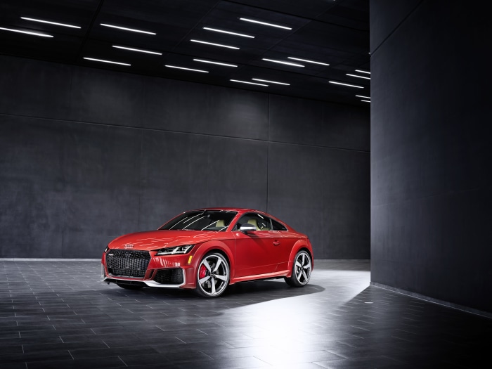Red Audi TT RS Coupe in a modern showroom