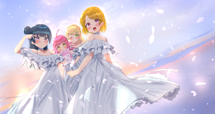 Four girls in white dresses in front of a sunset sky