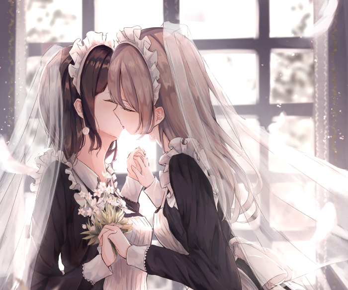 Two maids in wedding dresses kissing