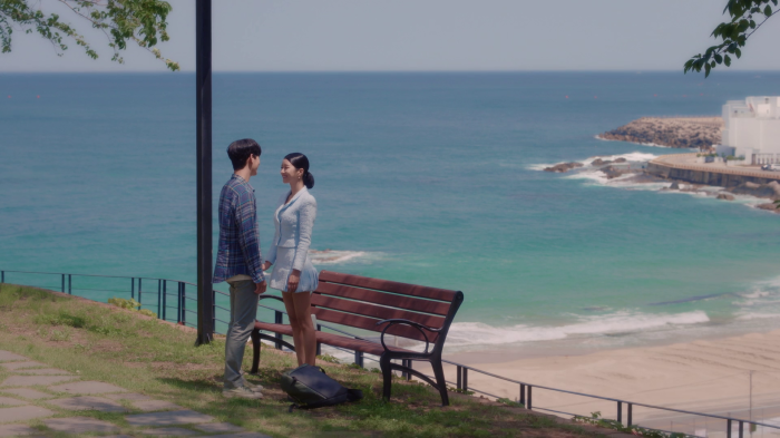 Couple standing by the sea in a K-drama