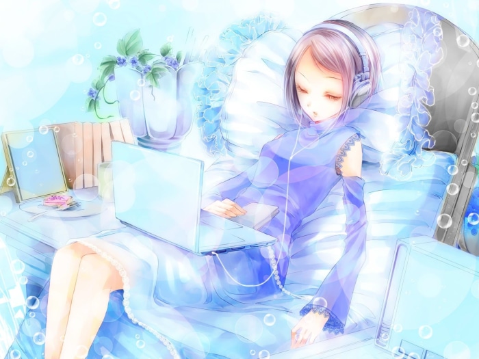 Girl with headphones using a laptop