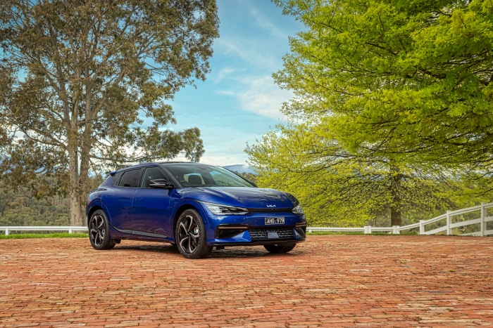 Blue Kia EV6 GT Line electric SUV on brick patio